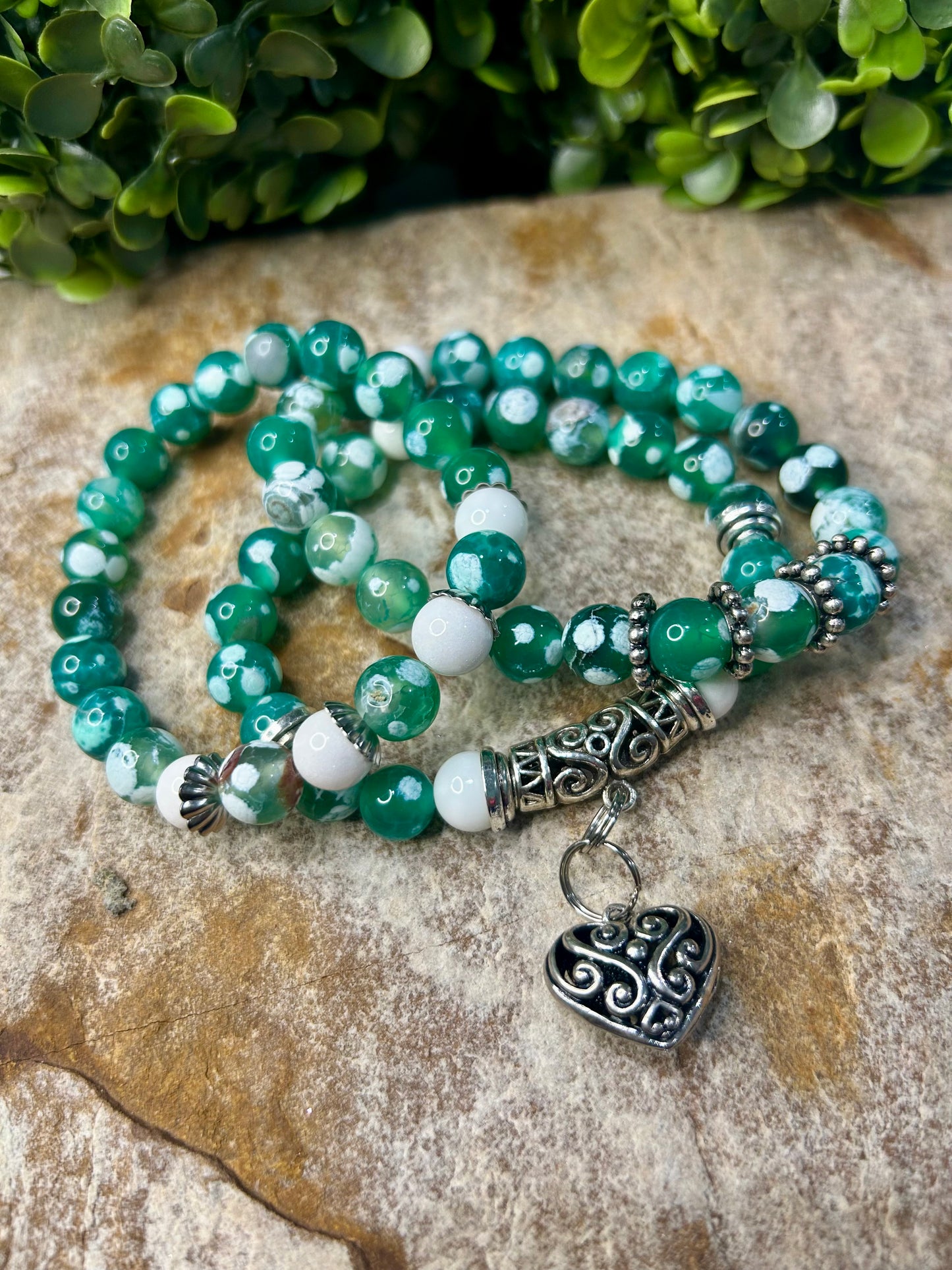 Stunning green fire agate adorned with beautiful accented charms!