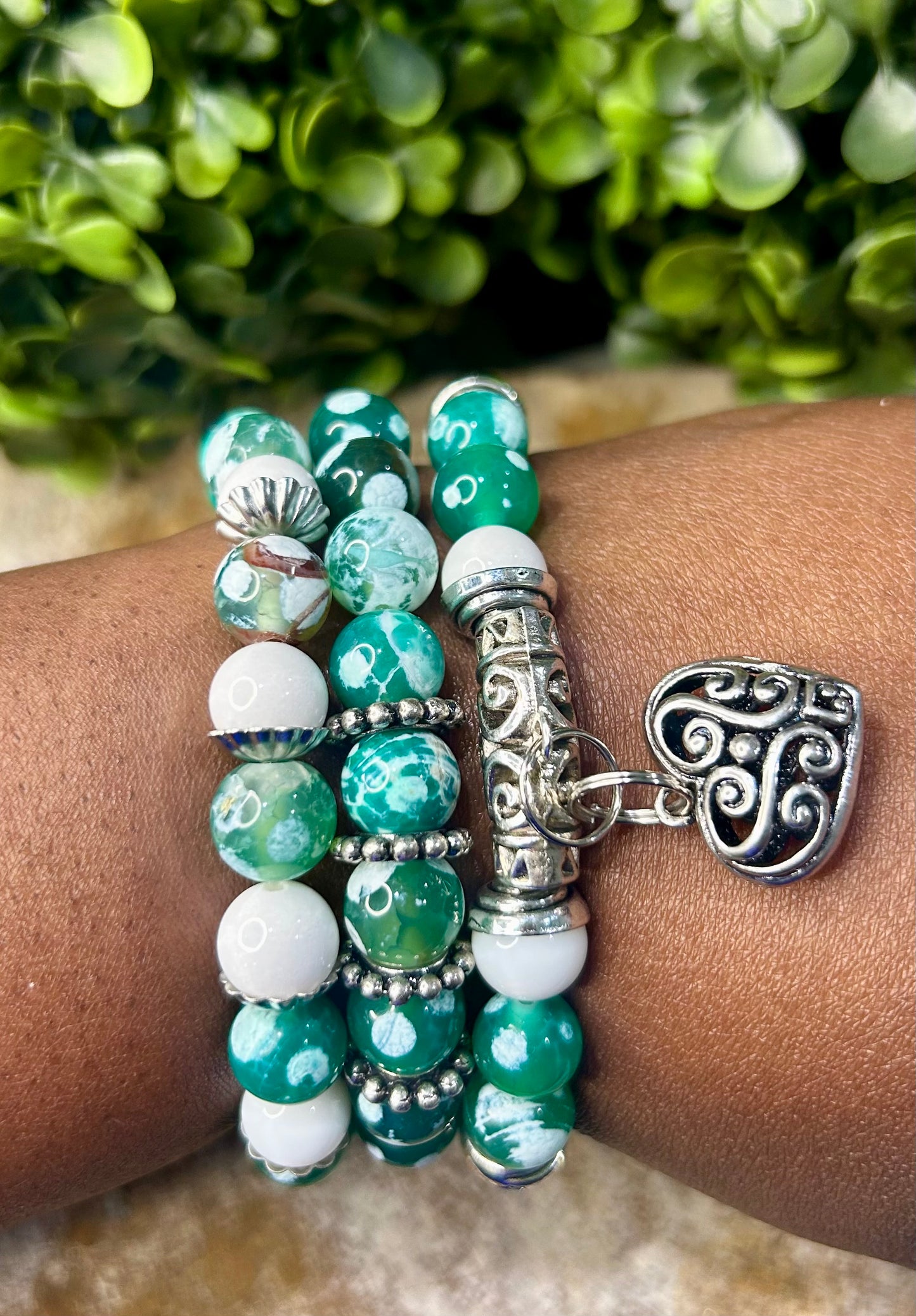 Stunning green fire agate adorned with beautiful accented charms!