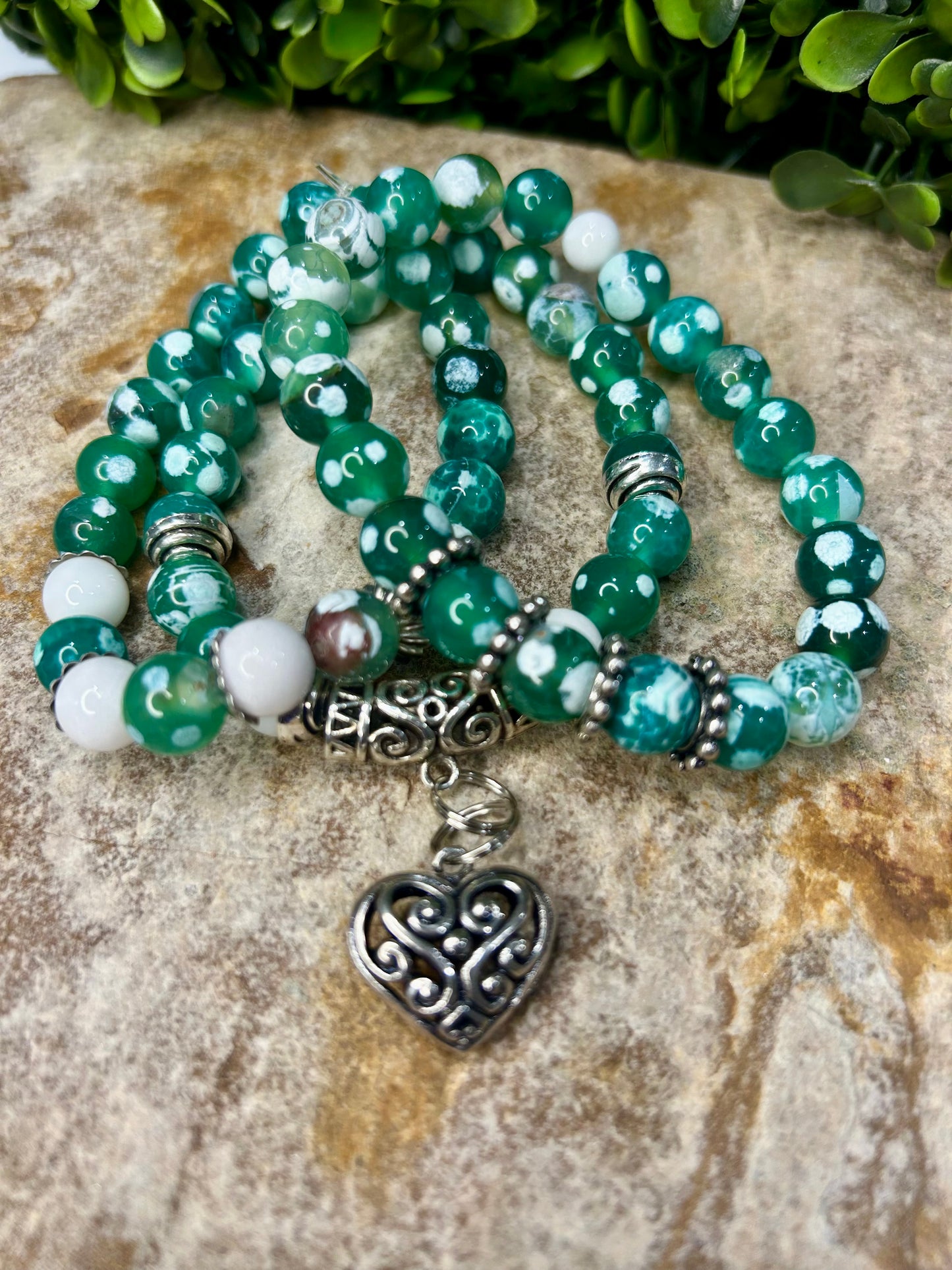 Stunning green fire agate adorned with beautiful accented charms!